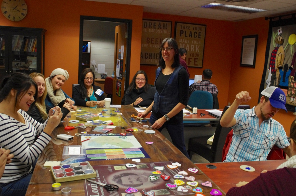 Bead-In organizer Leanna Marshall, centre, and a group of participants bead their fabric hearts during Confederation College’s Bead-In in Honour of Missing and Murdered Aboriginal Women, held during Aboriginal Awareness Week 2015.  Photo by Rick Garrick 