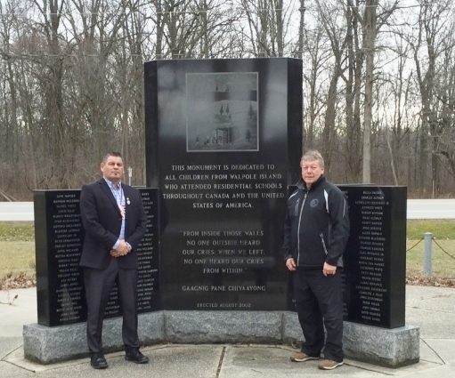 Ontario Regional Chief Isadore Day with Bkejwanong/Walpole Island Chief Dan Miskokomon at the Indian Residential School Memorial in the First Nation.